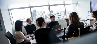 UBC Staff members having a discussion in a boardroom on campus