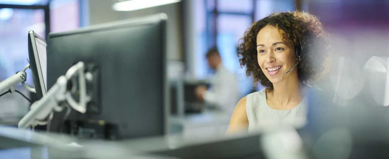 A woman looking at a computer monitor